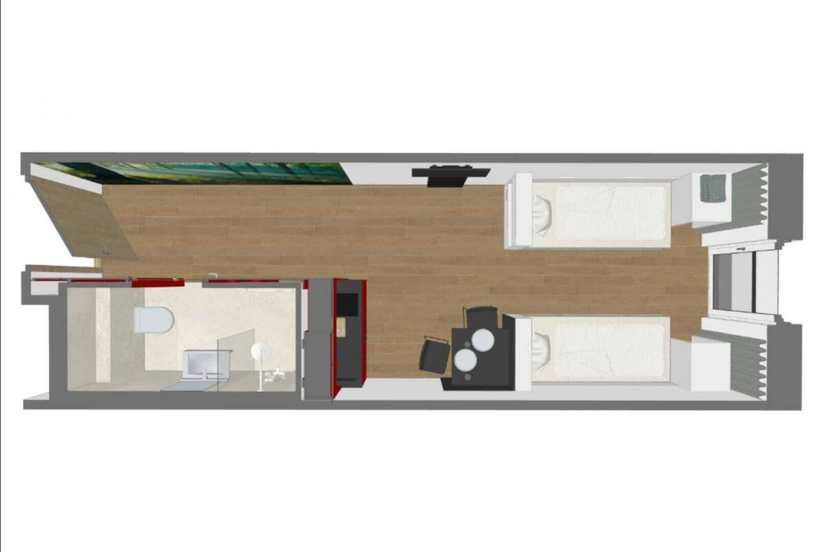 Ein Grundriss eines Hotelzimmers mit einem Bett, einem Schreibtisch, einem Sessel, einem kleinen Tisch und einer Couch.