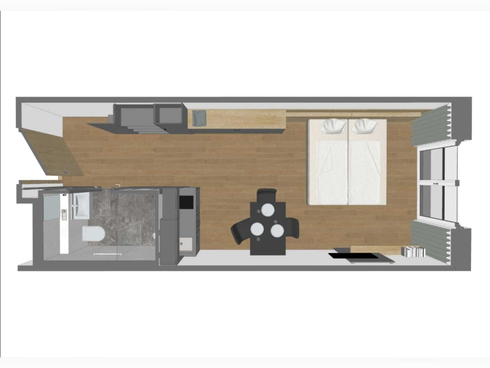 Plano de planta de una habitación de hotel con kitchenette, baño, zona de estar y un amplio ventanal.