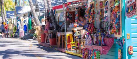 A colorful street market with various stalls selling crafts and souvenirs.
