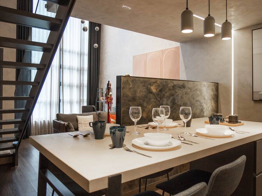 A modern dining area with a long table set for four, featuring a minimalist design with a neutral color palette.