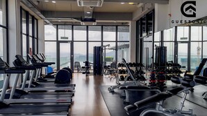 A gym with treadmills, weight machines, and dumbbells. - Guestonic EkoCheras Cozy Studio (Kuala Lumpur)