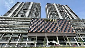 A high-rise building with a prominent 'NETIZEN' sign on the facade, multiple balconies, and a clear sky in the background. - Guestonic Netizen Cozy Studio (Cheras)