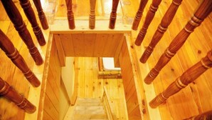 A wooden staircase leading to a balcony with a wooden railing. - Virman Riverside Resort (Banjar)
