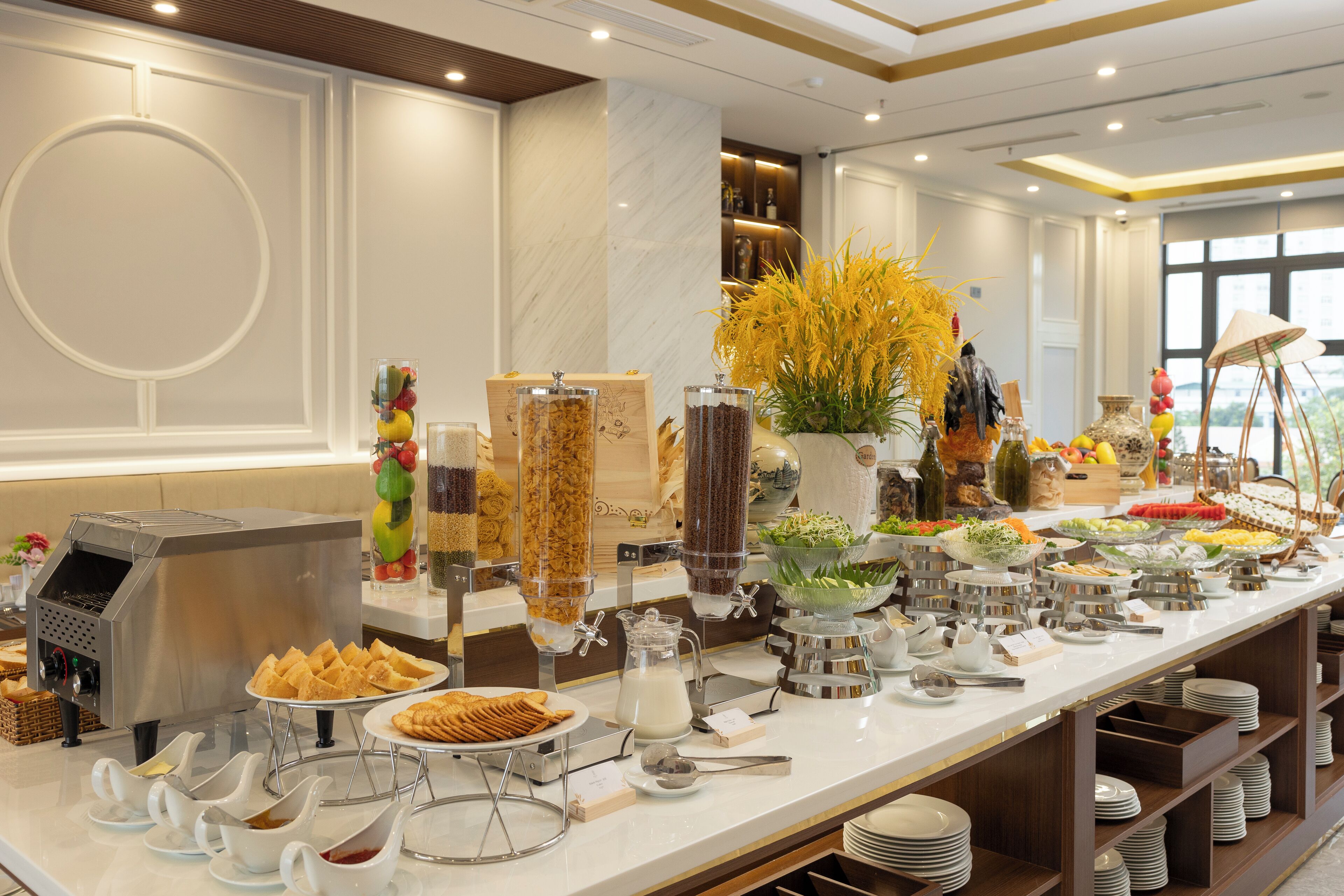A buffet setup with various food items and a coffee machine.