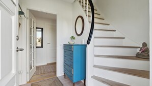 A staircase with wooden steps and a white wall.