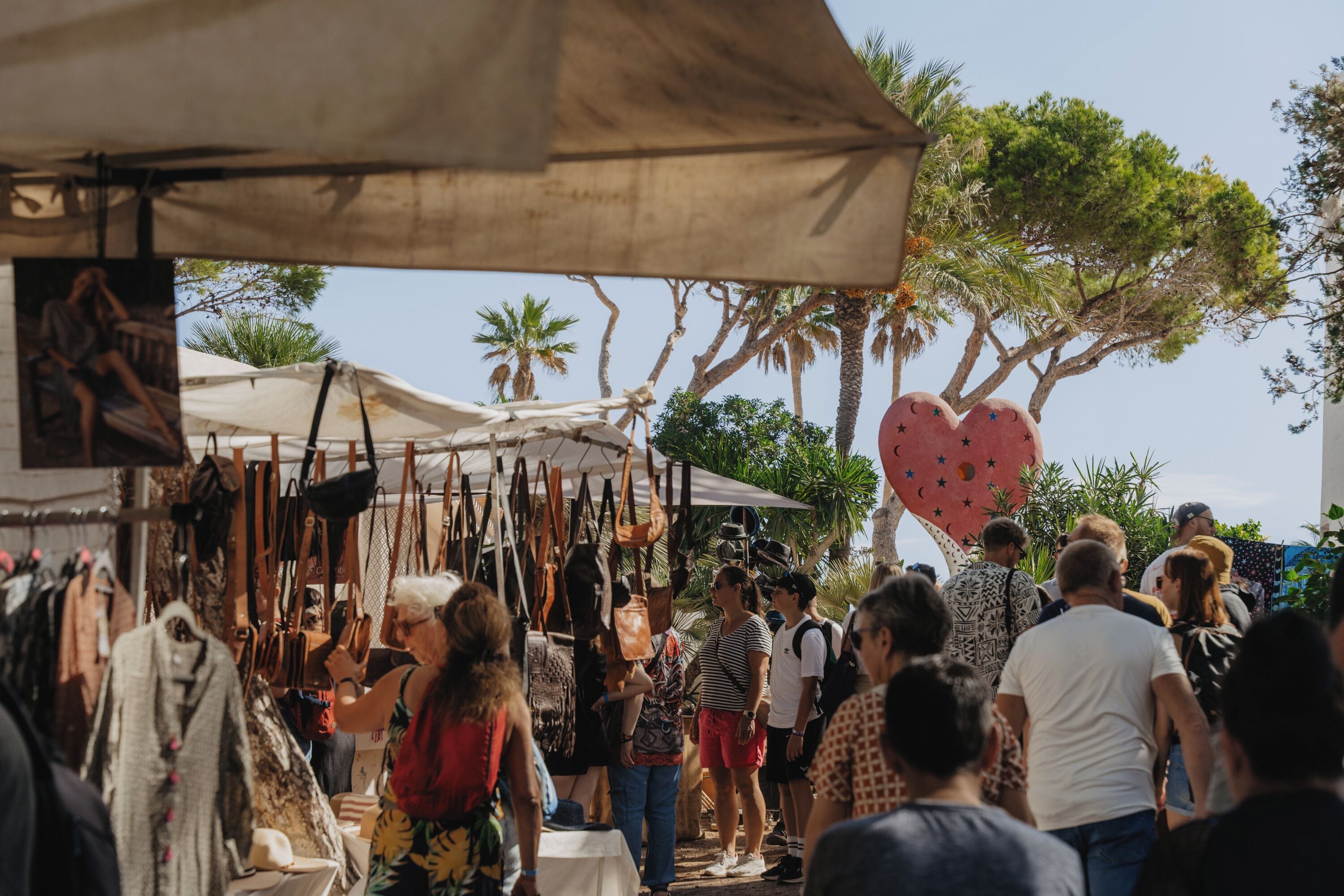 Ein belebter Markt im Freien mit zahlreichen Ständen und Besuchern.