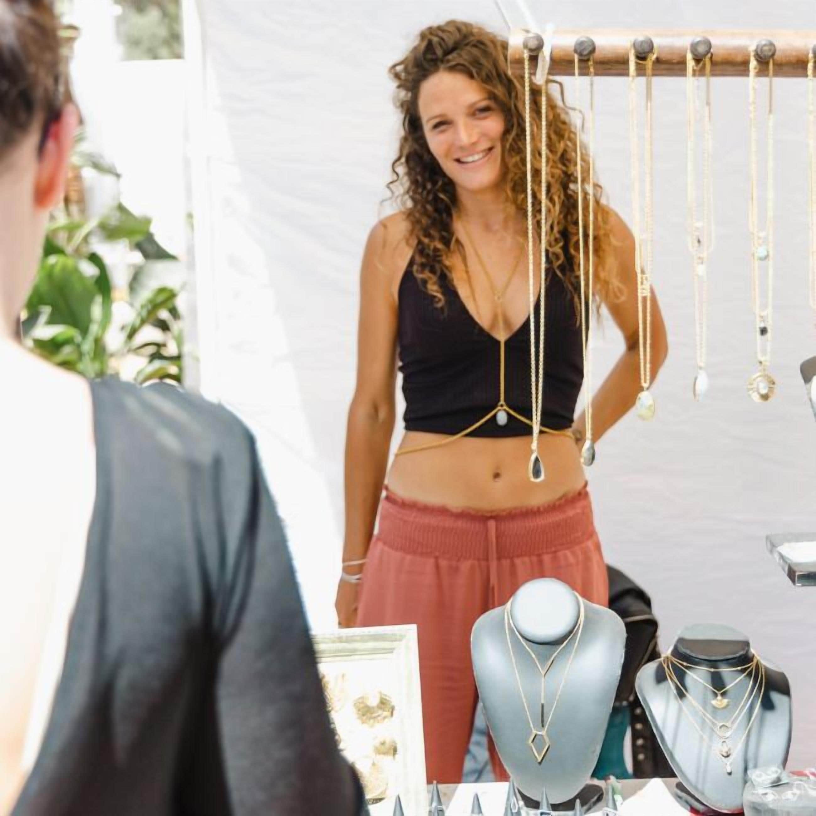 A jewelry display with various necklaces and a mannequin.