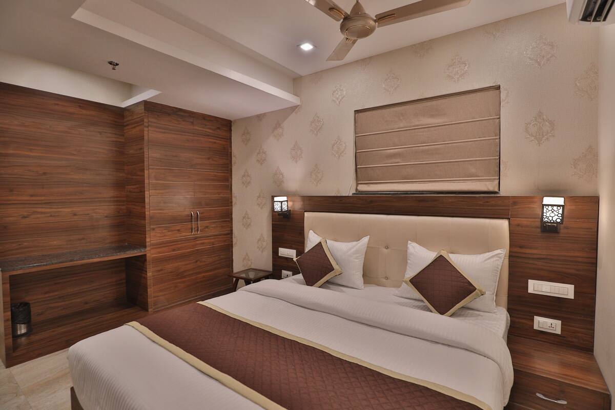 Ein Schlafzimmer mit einem großen Bett, einem Holzschrank und einem Deckenventilator.