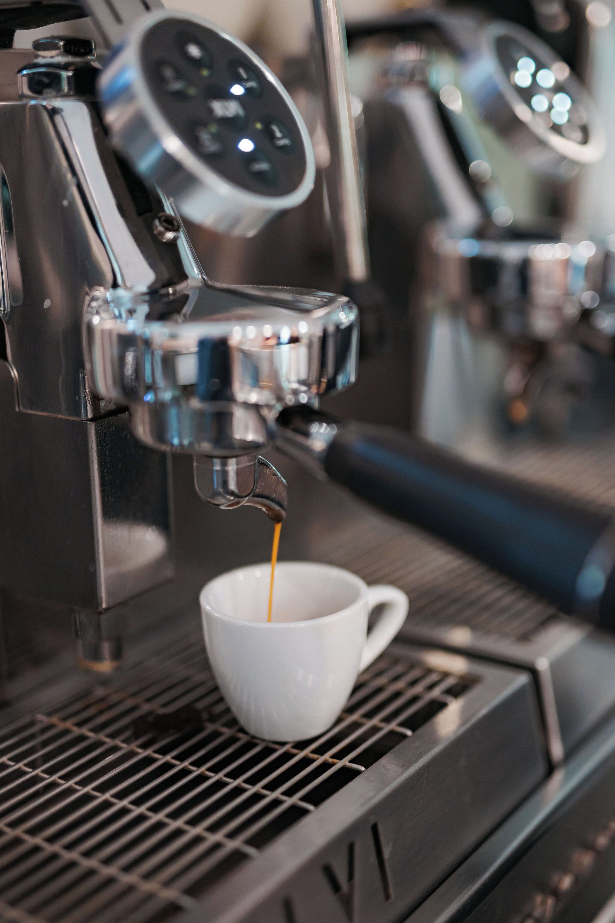 A coffee machine dispensing coffee into a cup.