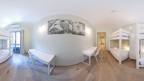A room with bunk beds, a desk, and a large wall mural. - Tomato Urban Retreat (Turin)