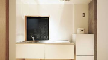A modern kitchen with a built-in window, a sink, and a refrigerator.