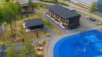 Stunning complex with a sports court and lush green surroundings.