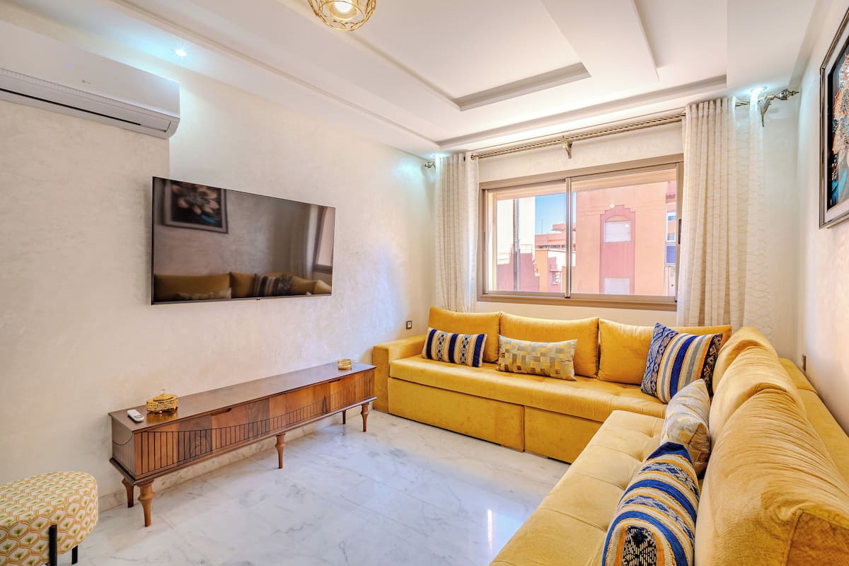 Standard Apartment | Living area | 40-inch flat-screen TV with digital channels