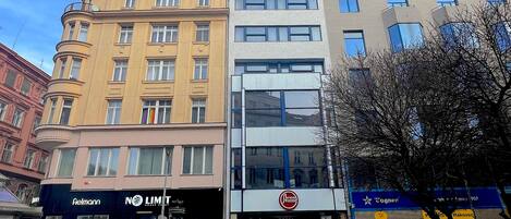 A hotel with a modern facade, large windows, and a visible entrance.