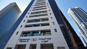 A high-rise building with a sign reading "Goldcrest Views-2". - Cosmos Living Charming Studio With Balco (Dubai)