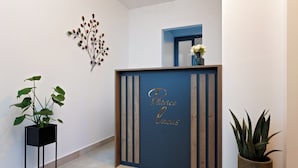 A reception desk with a blue backdrop and a sign that reads "Platinum Locus." - PLITVICE LACUS (Rakovica)