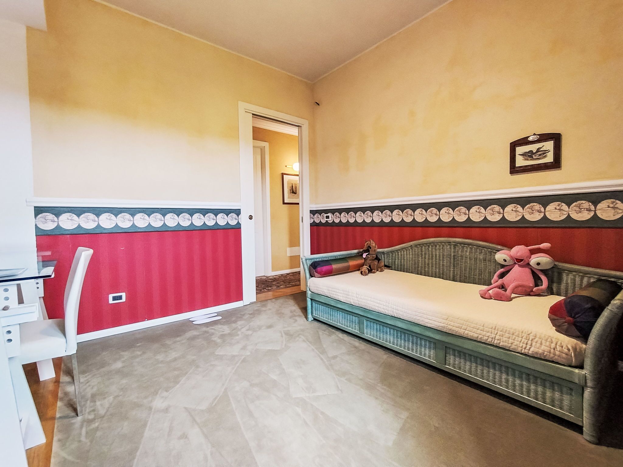 A room with a bed, a chair, and a desk.