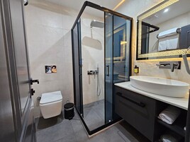Shower, hair dryer, slippers, towels
