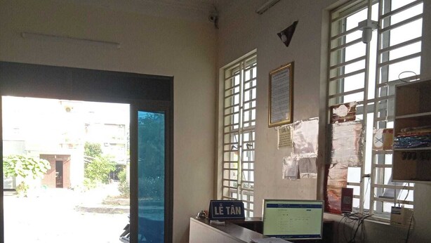 A reception area with a desk, computer, and a sign reading "LE TAN". - Minh Long Guesthouse - Quang Truong (Thuc Phan)