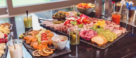 A buffet with various foods and drinks.