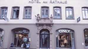 The facade of Hotel Am Rathaus with a clear entrance, a 'ONLY' sign, and a display of clothing outside. - Hotel am Rathaus (Freiburg im Breisgau)