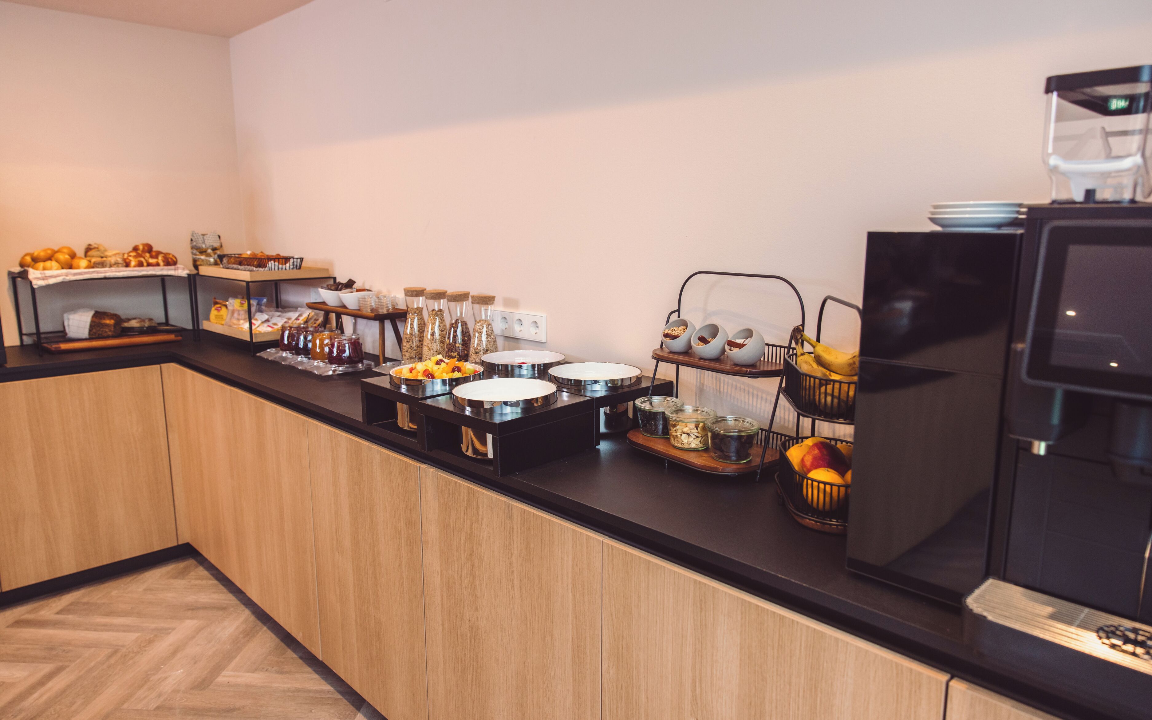 A buffet setup with various food items and condiments.