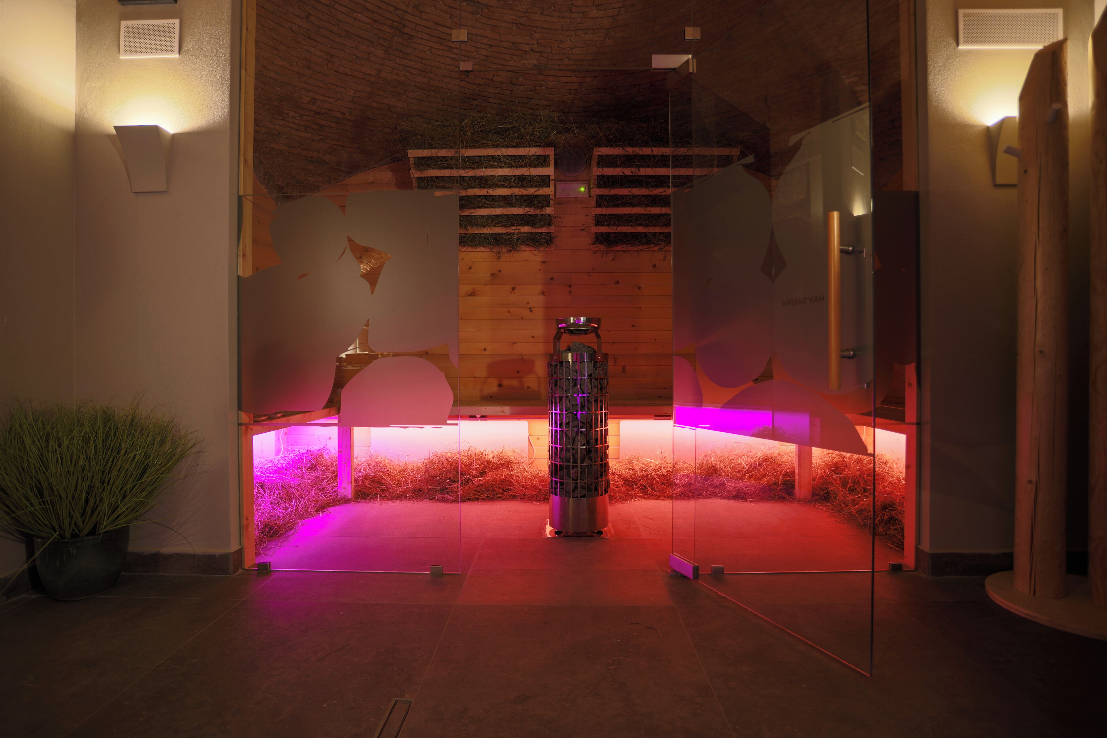 A modern interior with a central metallic sculpture, wooden accents, and ambient lighting.