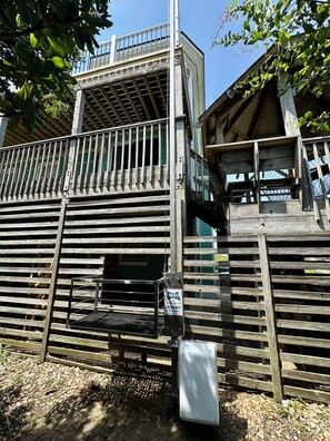 A wooden structure with a metal gate, a ladder, and a sign with contact information. - 6BR ocean-side Corolla retreat with pool, hot tub, and beach access. CP-47 (Corolla)