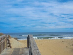 A wooden boardwalk leading to a sandy beach with the ocean in the background. - 6BR ocean-side Corolla retreat with pool, hot tub, and beach access. CP-47 (Corolla)