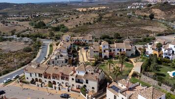 A coastal town with traditional architecture, a main road, and a view of the sea.