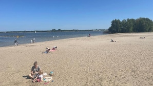 A beach with people relaxing and playing.