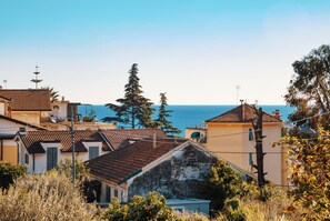 A coastal village with traditional architecture, including terracotta-tiled roofs and a mix of residential buildings. - Art Apartment by Wonderful Italy (Sanremo)