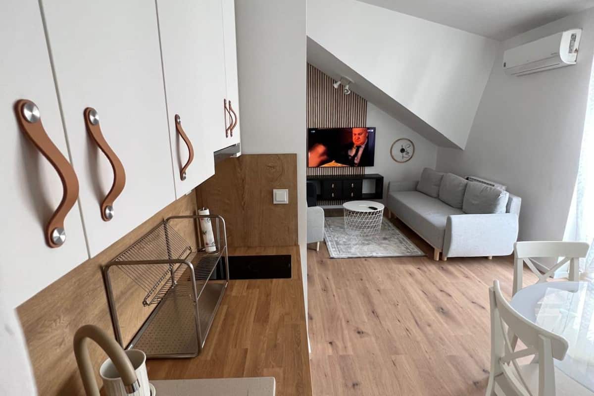 A modern apartment with a kitchen, living area, and a dining space.