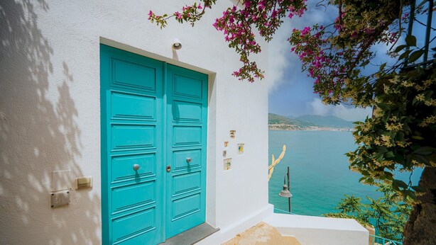 A turquoise door with a white wall and a view of the sea. - Villa San Michele by Elite Villas (Cetara)