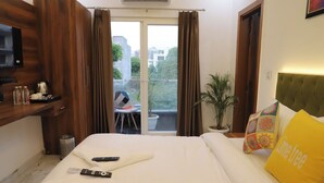 A hotel room with a bed, a TV, a balcony with a chair, and a potted plant. - Opulent Inn By Lime Tree Hotels (Greater Noida)