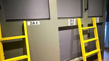 A room with two yellow ladders, each with a sign indicating directions to different areas.