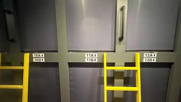 A row of closed doors with labels indicating room numbers and directions for access.