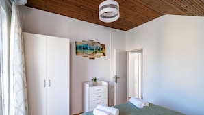 A bedroom with a bed, a wardrobe, a dresser, and a door. - Apartment Dorica (Dubrovnik)