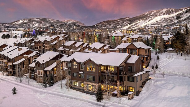 A snow-covered resort with multiple multi-story buildings, likely offering lodging and amenities.