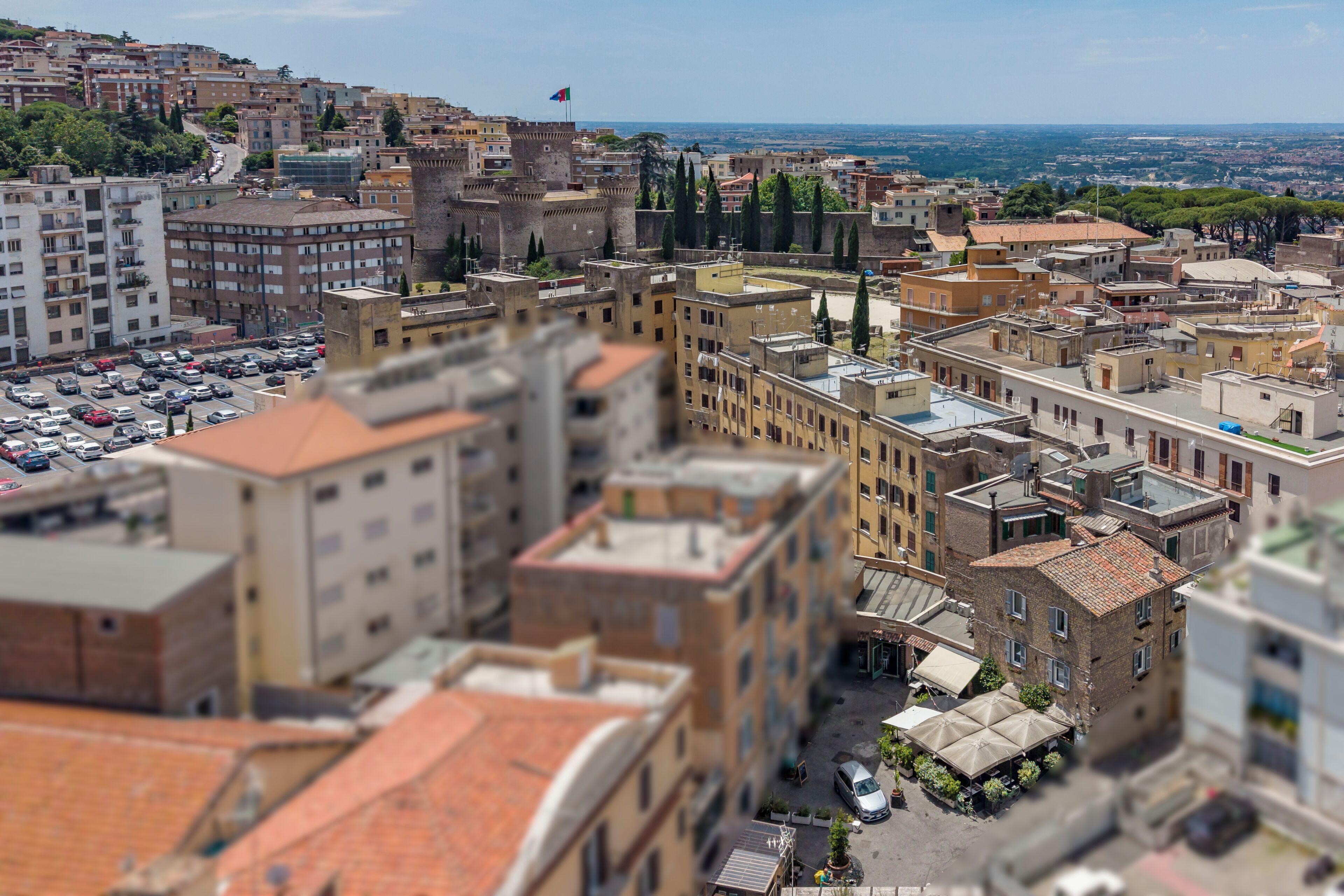 A cityscape with historic buildings, a castle, and a view of the surrounding area.