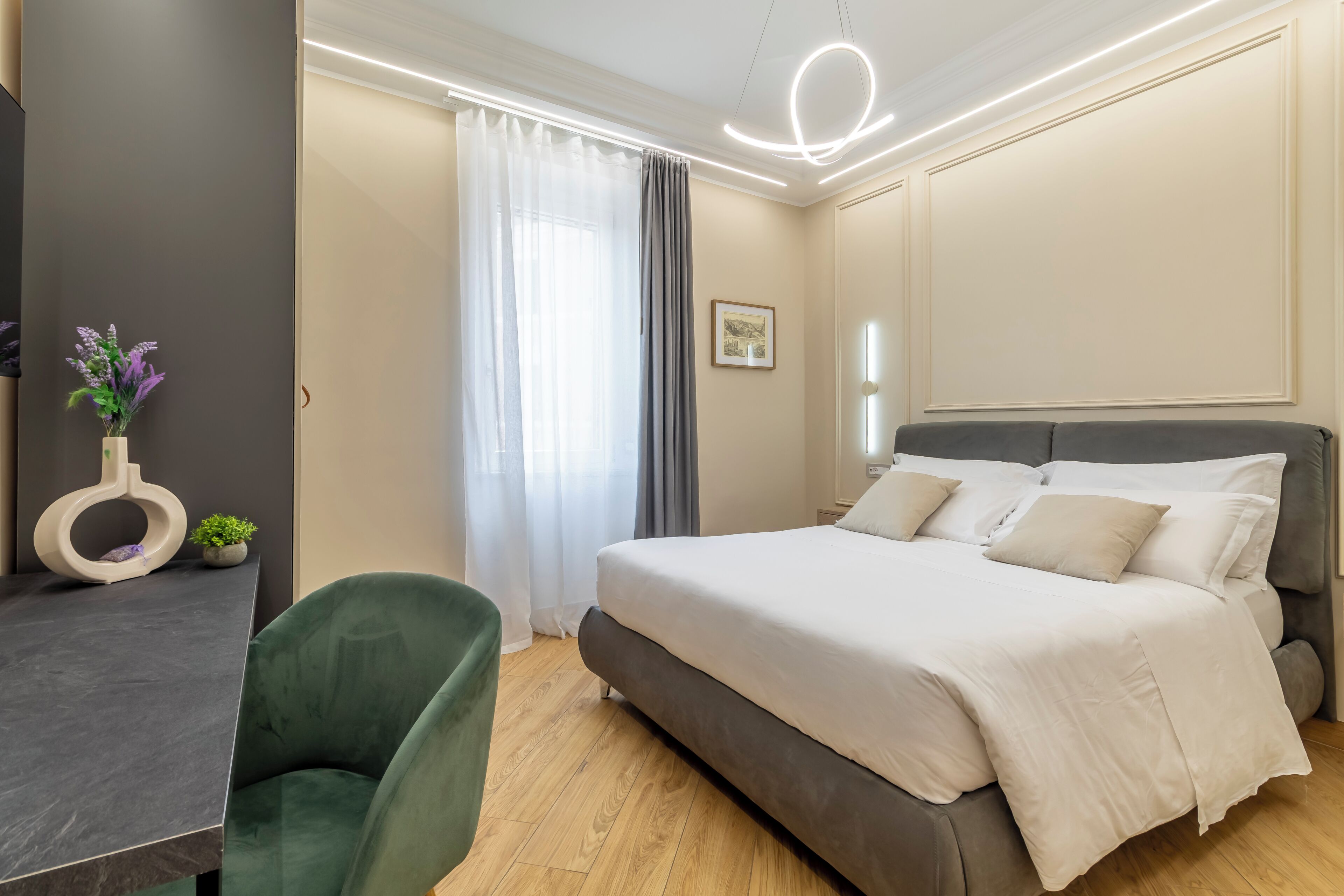 A modern bedroom with a bed, a desk, and a chair.