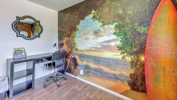 A room with a desk, a chair, and a large mural of a beach scene. - Family-friendly Clovis Home w/ Gas Grill + Patio! (Clovis)