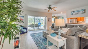 A living room with a ceiling fan, a sofa, a coffee table, and a large plant. - 4 Mi to Rainbow Springs: Dunnellon Home w/ Pool! (Dunnellon)