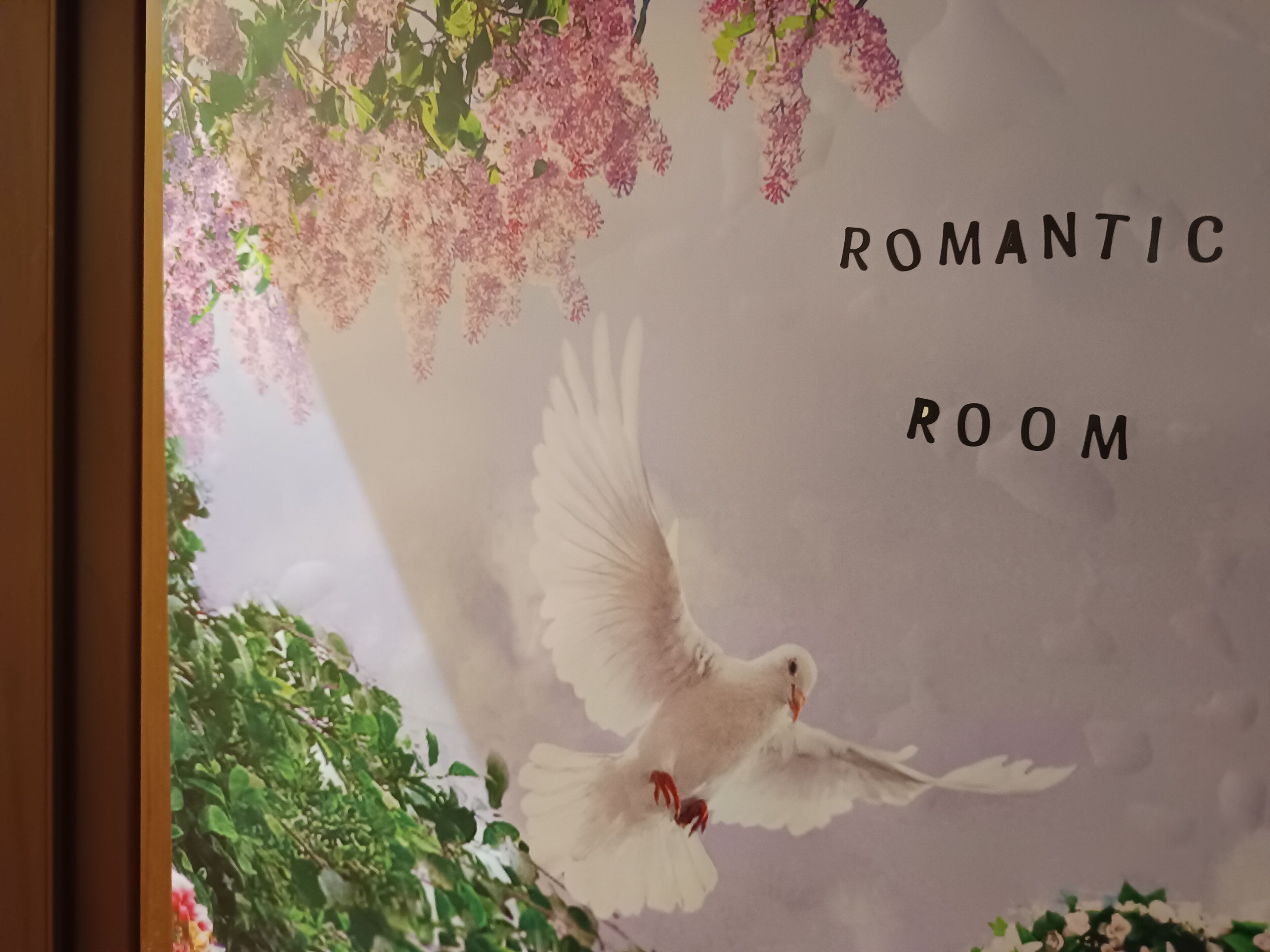 A room with a white dove and floral decorations, labeled "Romantic Room".