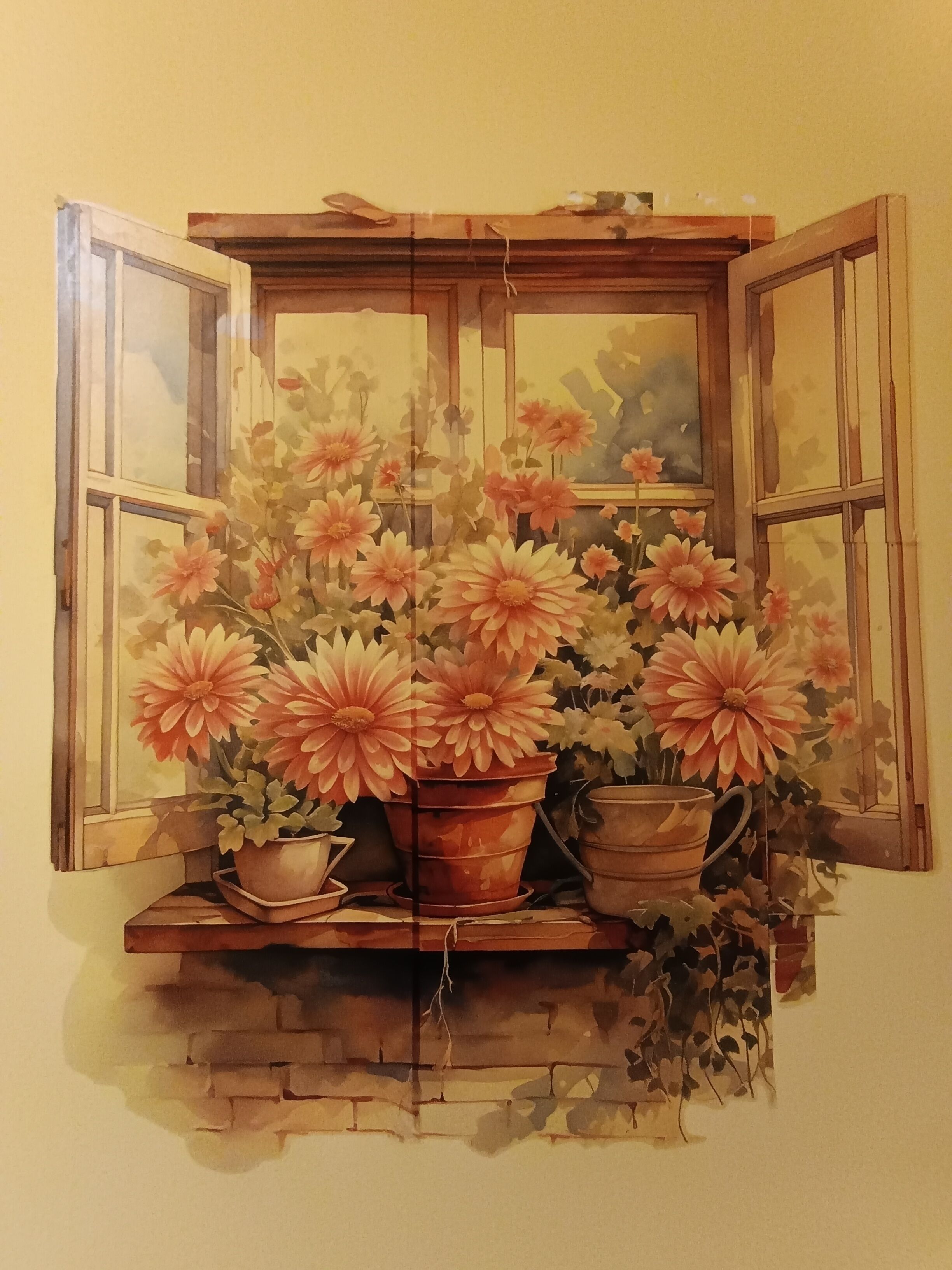A window with a view of flowers and a brick wall.