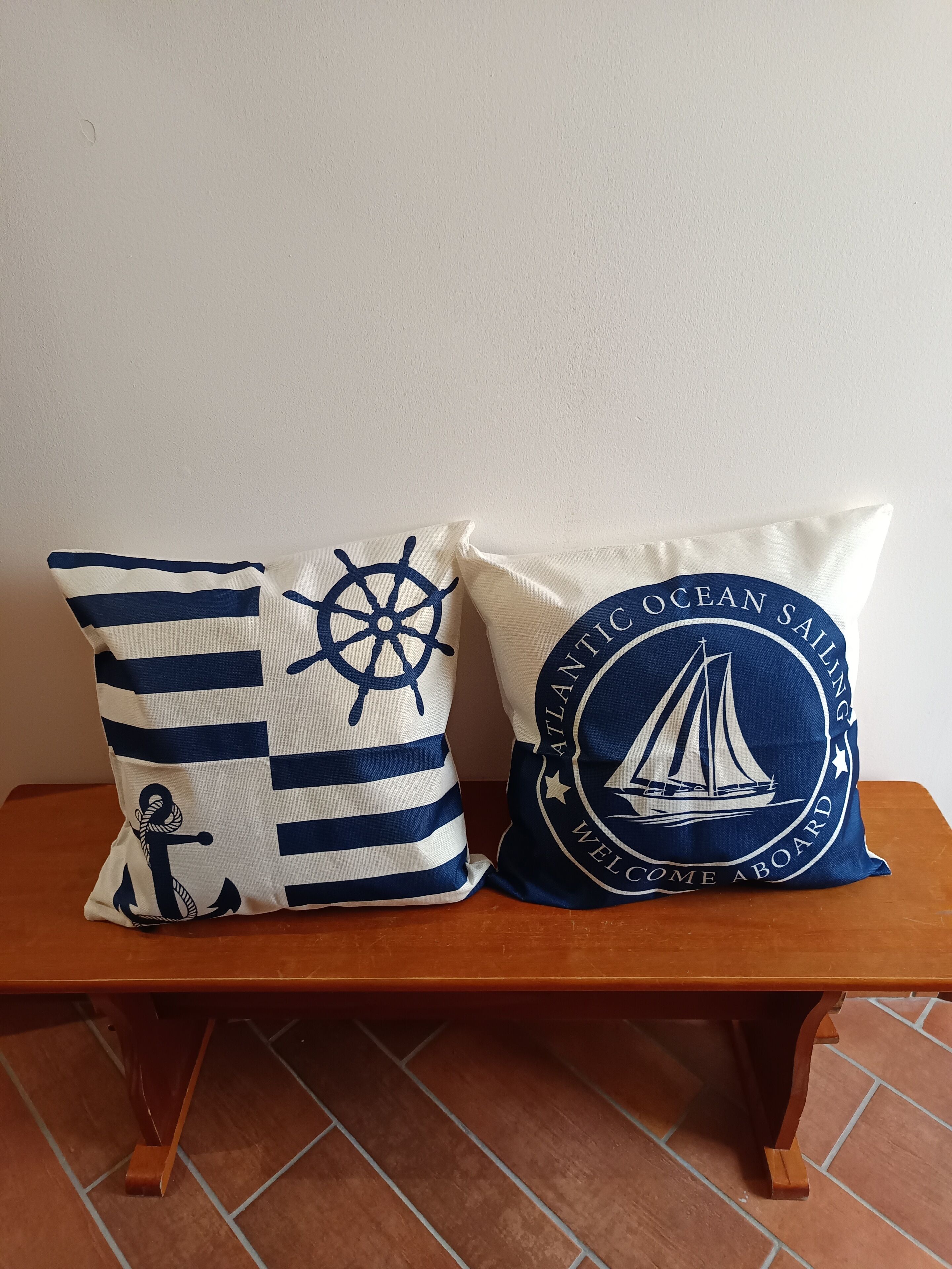 Two pillows on a wooden bench.