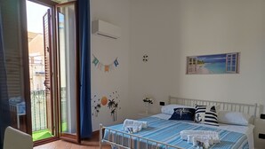 A bedroom with a bed, a window with a view, a wall-mounted air conditioner, and a door leading to an outdoor area. - A casa di Peppe (Palermo)