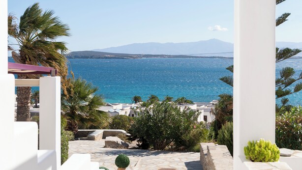 A coastal view with a clear sky, a body of water, and distant mountains.
