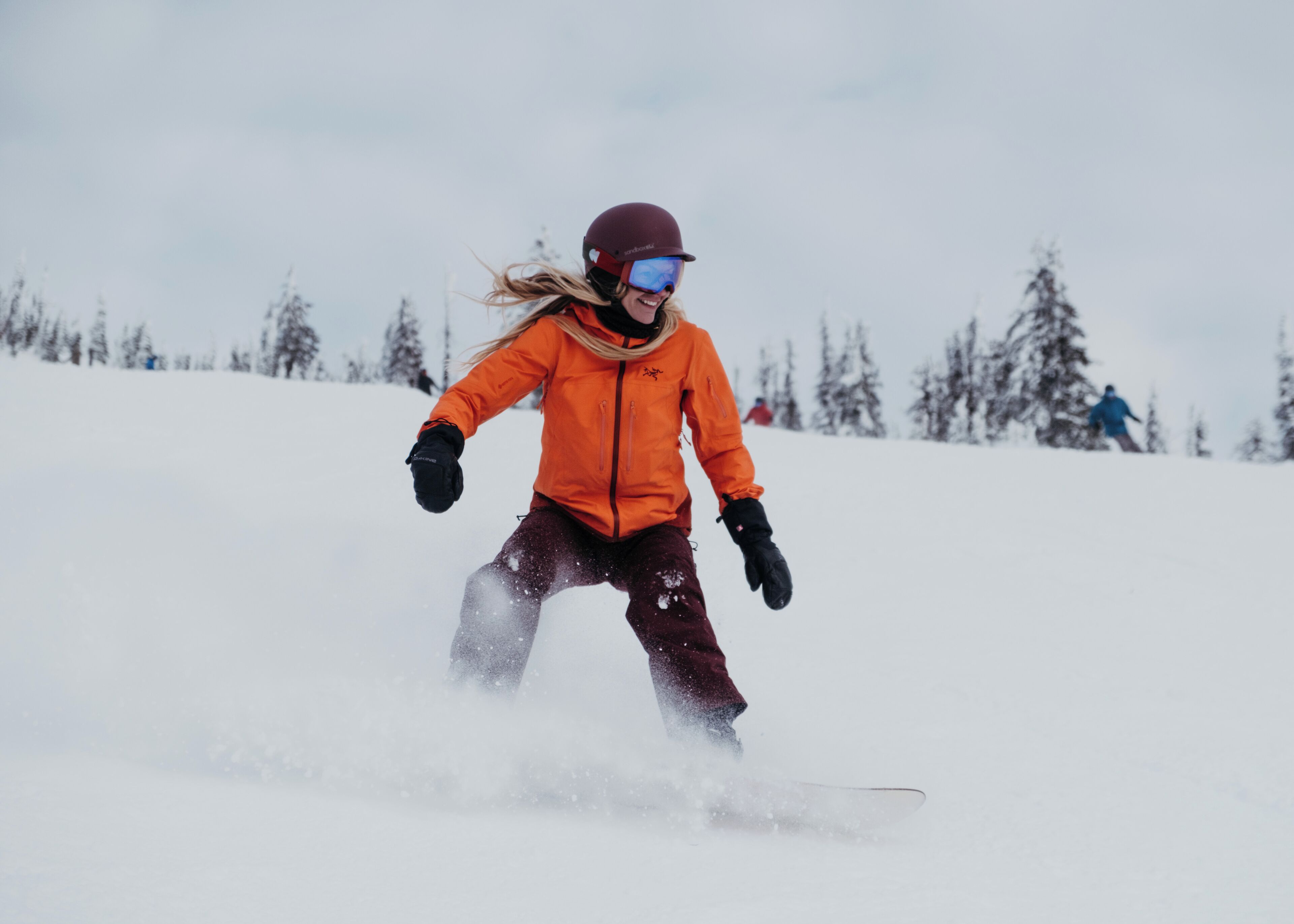 A person snowboarding down a snowy slope.