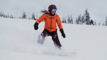 A person snowboarding down a snowy slope.